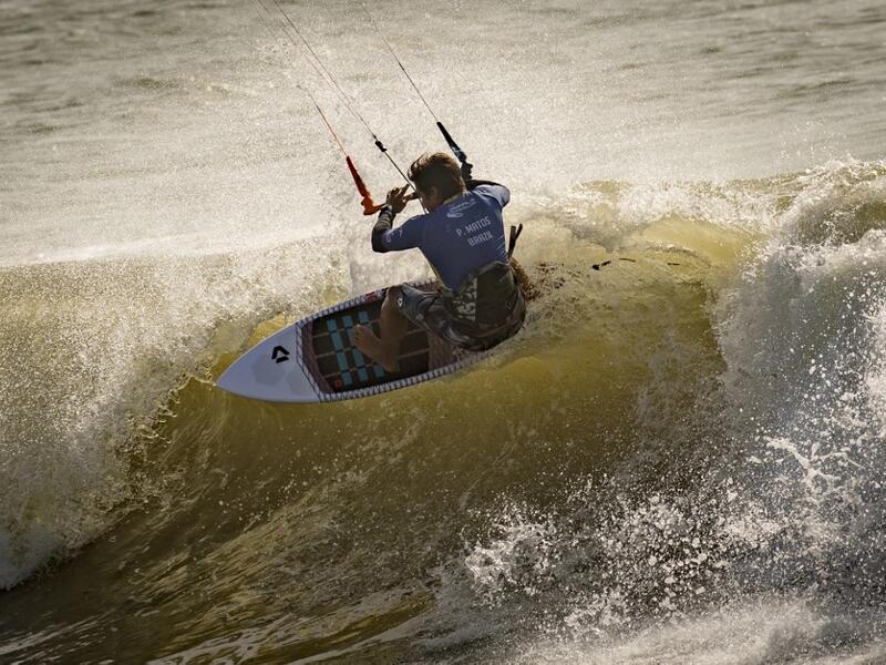 A picture taken on October 10, 2019, shows a kitesurfer riding waves at Dakhla beach in Morocco-administered Western Sahara. In the heart of disputed Western Sahara, a former garrison town has become an unlikely tourist magnet after kitesurfers discovered the windswept desert coast on the Atlantic is perfect for their sport. FADEL SENNA / AFP