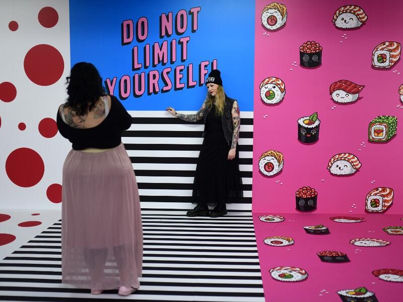 A woman is being photographed at the "Supercandy Pop-Up Museum Vol. 2" in Cologne, western Germany on November 1, 2019. It is an interactive museum and offers a photo backdrop for social media at 25 stations. INA FASSBENDER / AFP