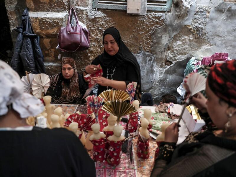 Egyptian women decorate traditional sugar statuettes in the capital Cairo on November 2, 2019, ahead of celebrations of the Muslim Prophet Mohammed's birthday, known as "Al Mawlid Al Nabawi". Prophet Mohamed was born in Saudi Arabia's arid mountainous city of Mecca, the holiest in Islam, some 1490 years ago. Sunni Muslims in many parts of the world celebrate his birthday on the 12th day of the third month of the Islamic calendar, which will fall this year on November 9th.  Mohamed el-Shahed / AFP