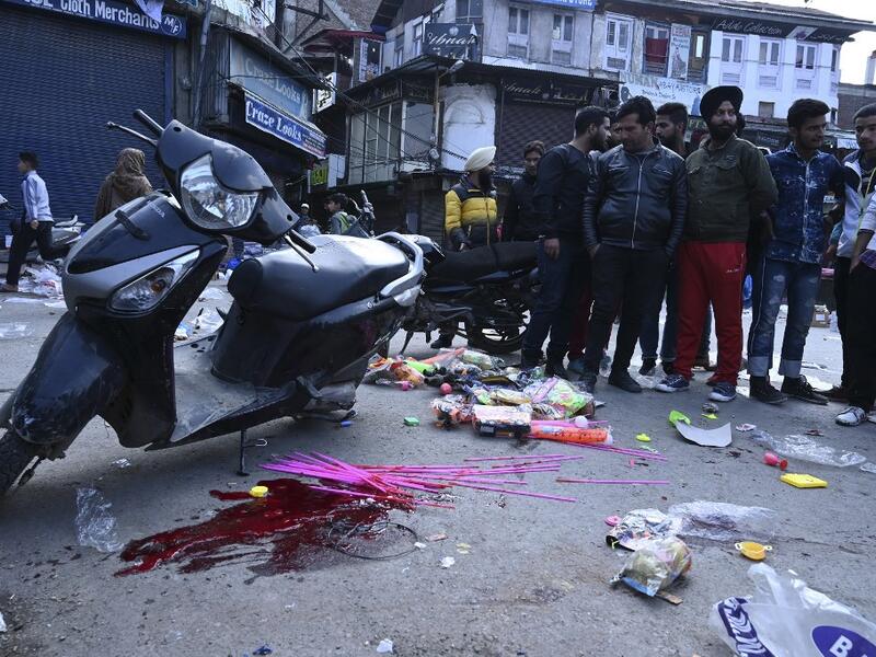 People gather at the site of a grenade blast at a market in Srinagar on November 4, 2019. At least one person was killed and 17 injured on November 4 in a grenade blast at a crowded market in Indian-administered Kashmir's main city of Srinagar, police and doctors said. Tauseef MUSTAFA / AFP