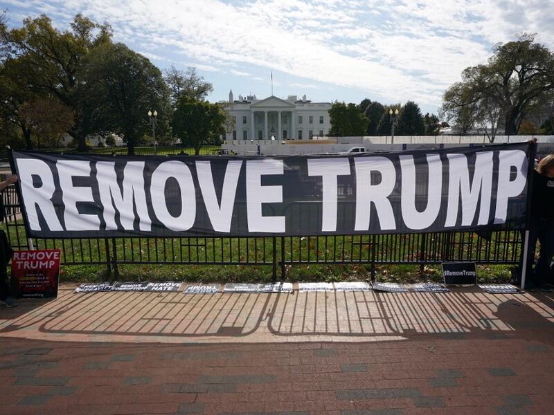 Activists hold a banner asking for the impeachment of US President Donald Trump on November 5, 2019 in front of the White House in Washington,DC. US voters headed to polls Tuesday in several states with governorships or legislatures at stake, in early tests of enthusiasm for and against President Donald Trump ahead of the 2020 elections. Mandel Ngan / AFP