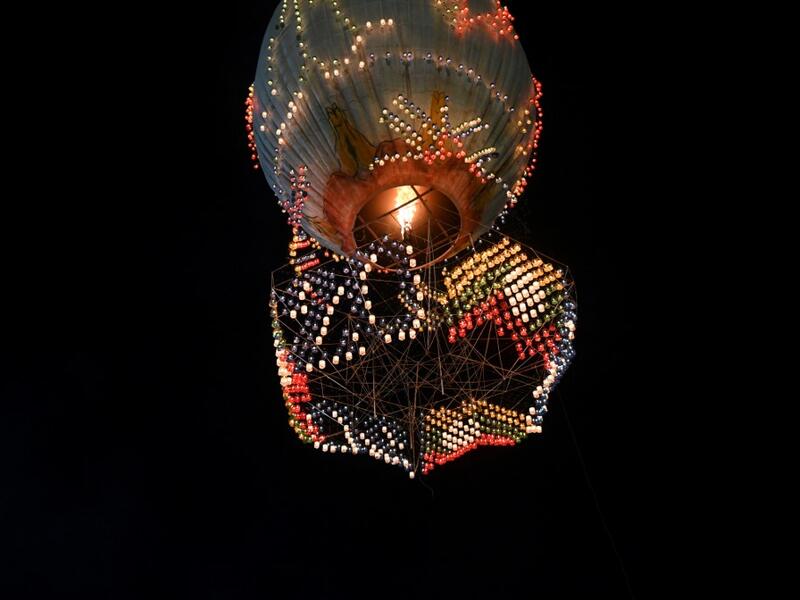 This picture taken on November 6, 2019 shows a hot-air balloon attached with fireworks taking off during the Tazaungdaing Lighting Festival at Taunggyi in Myanmar's northeastern Shan State. Brightly coloured balloons with hundreds of homemade fireworks woven into their frames are sent soaring into the night sky, showering down cascades of sparks onto adoring crowds in the annual Taunggyi fire balloon festival. Ye Aung THU / AFP