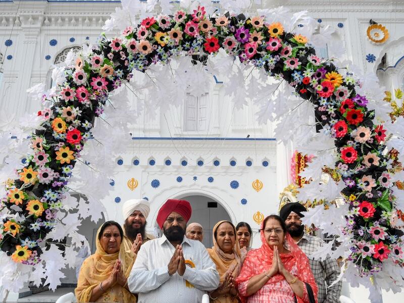 Sikh pilgrims pray as they take part in a ritual procession at a shrine in Nankana Sahib, some 75 kms west of Lahore on November 7, 2019, on the occasion of the 550th birth anniversary of Guru Nanak Dev. Arif ALI / AFP
