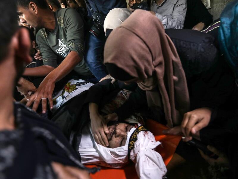Palestinian relatives of Islamic Jihad militant Abdullah al-Belbasi mourn during his funeral in Beit Hanun in the northern Gaza Strip on November 13, 2019. Two more Palestinians were killed in an Israeli strike in the Gaza Strip, the enclave's health ministry said, as Israel said it was targeting rocket-launching squads and militant sites. The deaths brought the Gaza toll to 18 people killed since an exchange of fire began on Tuesday with an Israeli targeted strike on an Islamic Jihad commander sparking ret