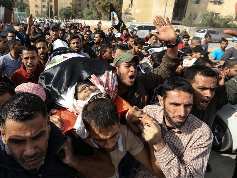 Palestinian mouners carry the body of Islamic Jihad militant Abdullah al-Belbasi during his funeral in Beit Hanun in the northern Gaza Strip on November 13, 2019. Two more Palestinians were killed in an Israeli strike in the Gaza Strip, the enclave's health ministry said, as Israel said it was targeting rocket-launching squads and militant sites. MAHMUD HAMS / AFP