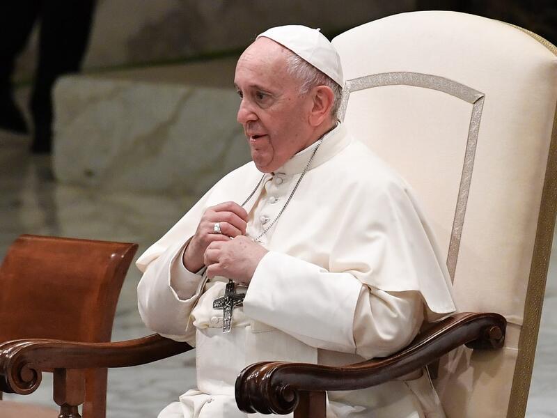 Pope Francis adjusts his iron cross necklace during an audience with students and teachers of Roma's LUMSA Catholic University, on November 14, 2019 at Paul-VI hall in the Vatican. Andreas SOLARO / AFP