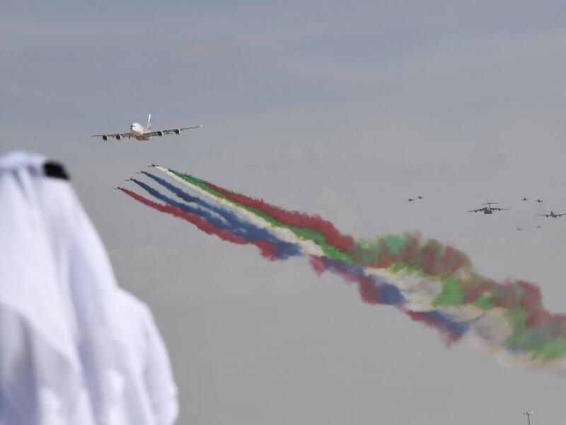 An emirati man watches the United Arab Emirates' air force Aerobatic Team, Al-Fursan, performing along with an Emirates Airline's Airbus A380 at the Dubai Airshow November 17, 2019. KARIM SAHIB / AFP