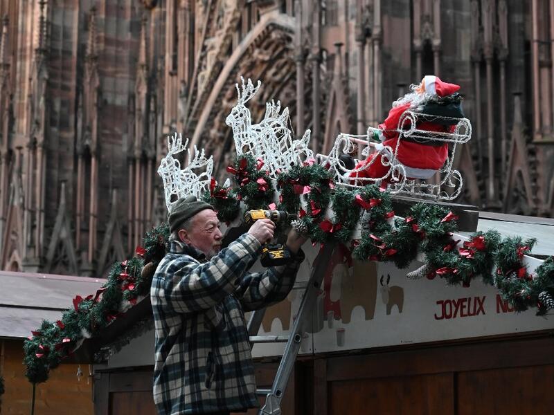 A worker installs the traditional Christmas market in Strasbourg, eastern France, on November 18, 2019, one year after the deadly attack, as the Christmas market of the city will open on November 22. PATRICK HERTZOG / AFP
