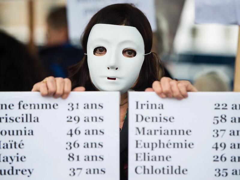 A woman holds a placard enumerating the names of feminicide victims in France in 2019, during a protest to condemn violence against women, on November 23, 2019 in Marseille, southern France. CLEMENT MAHOUDEAU / AFP
