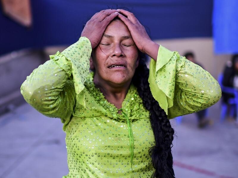 Bolivian wrestler Lidia Flores, aka "Dina, The Queen of the Ring", member of the Fighting Cholitas, gestures during a bout at Sharks of the Ring wrestling club in El Alto, Bolivia, on November 24, 2019. After a fortnight hiatus due to anti-government protests and blockades, the Fighting Cholitas are back in the ring. The unrest was triggered by the disputed October 20 election, which Evo Morales claimed to have won and opposition groups said was rigged. Ronaldo SCHEMIDT / AFP