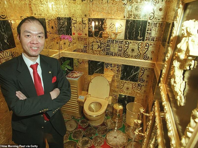 Winger Lam Sai-wing, a Hong Kong businessman, is pictured with his solid gold toilet in his office. The company chairman spent HK$38 million building the ultra-expensive washroom. (Daily Mail)