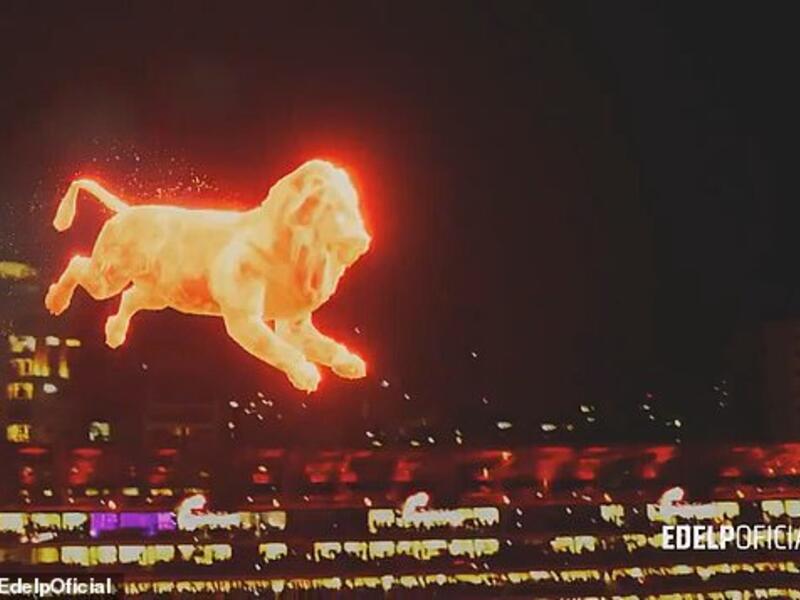 The lion is seen jumping onto the pitch as patches of turf erupt into 'flames' where the lion's feet touched the grass. (Daily Mail/ Golders/ Ede lpOfficial)