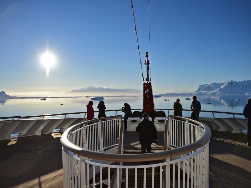 Tourists loot at the sunset from a ship at Chiriguano bay in the South Shetland Islands, Antarctica on November 07, 2019. Johan ORDONEZ / AFP