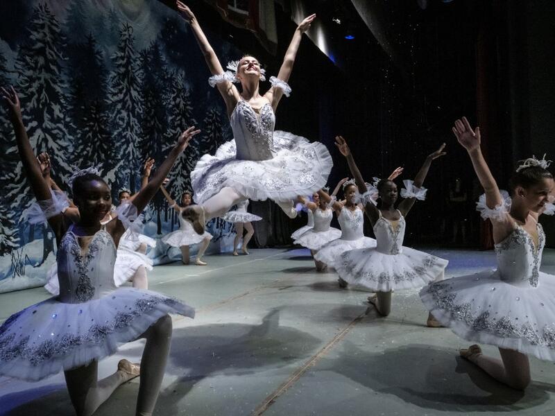 Members of Dance Centre Kenya (DCK) react in the wing stage during a production of the 'Nutcracker', a ballet primarily performed during the Christmas period as their annual show, along with the Nairobi Philharmonic Orchestra with foreign guest musicians at the National Heater in Nairobi, on December 8, 2019. DCK, founded by a few passionate families in early 2015, teach over 700 students at 3 studios in Nairobi, and provides lessons based on the Royal Academy of Dance Syllabus. Selected students in various