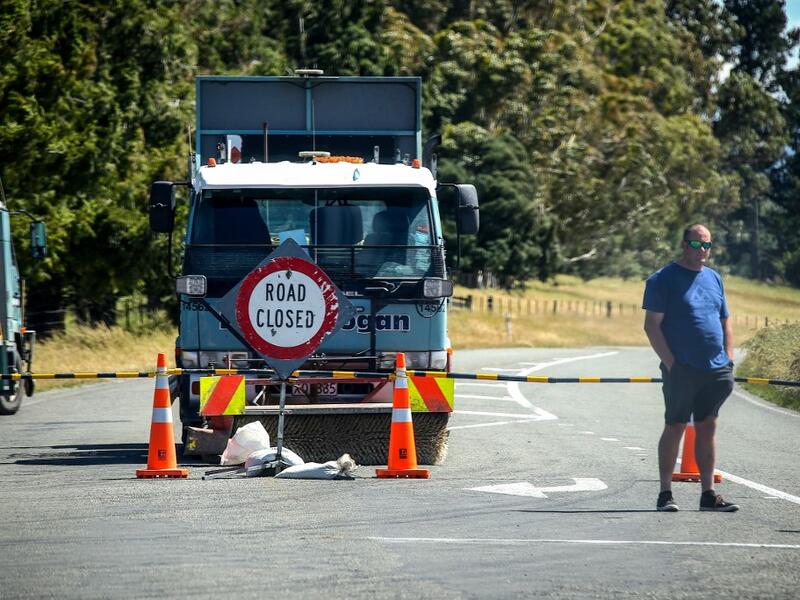 This photo taken on December 8, 2019 shows an official standing in front of a road block after the Rakaia River rose to dangerous levels, near the town of Geraldine on New Zealand's South Island. (AFP/ File Photo)