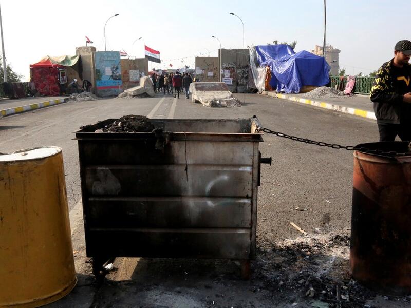 Iraqis gather at al-Sinek bridge in the capital Baghdad amid ongoing anti-government protests on December 9, 2019. SABAH ARAR / AFP