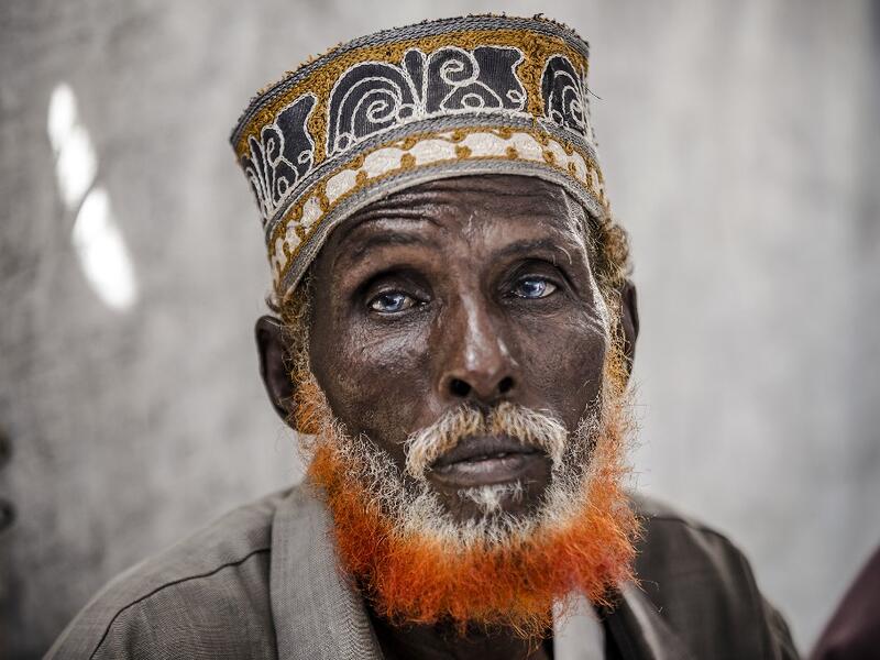 74-year-old Omar Dule, who lost his house due to the floods and heavy rains, gathers with some friends inside a United Nations tent at a displacement camp in Beledweyne, Somalia, on December 14, 2019. The rains have inundated big areas surrounding Beledweyne area forcing thousands of people to leave their houses and look for humanitarian assistance while living in displacement camps. Due to climate change and human activities, cycles of floods and droughts have become more recurrent and completely unpredict