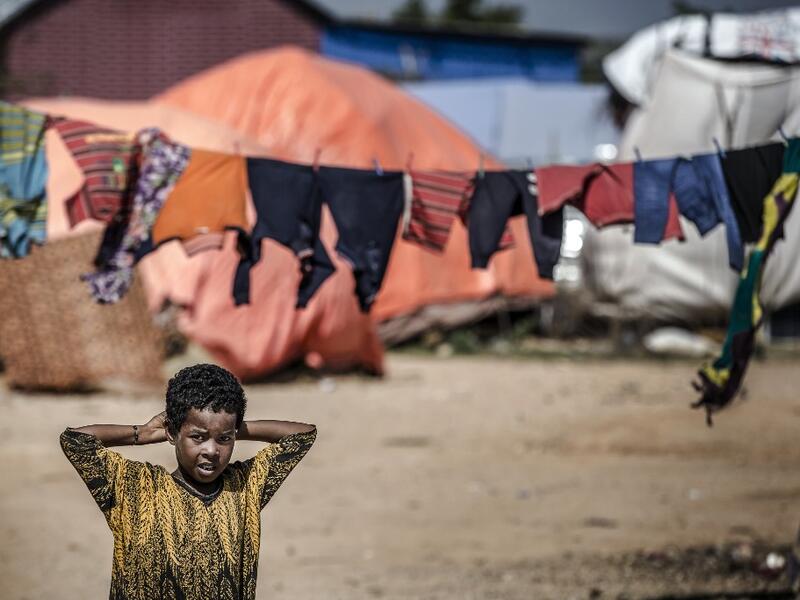 A girl stands next to her tent at a displacement camp for people affected by intense flooding in Beledweyne, Somalia, on December 14, 2019. The rains have inundated big areas surrounding Beledweyne area forcing thousands of people to leave their houses and look for humanitarian assistance while living in displacement camps. Due to climate change and human activities, cycles of floods and droughts have become more recurrent and completely unpredictable in Somalia exposing hundreds of thousands of people ever