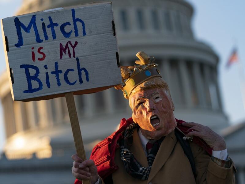 An anti Trump demonstrator protests outside the US Capitol Building in Washington, DC on December 18, 2019. The US House of Representatives is debating two articles of impeachment against US President Donald Trump. Alex Edelman / AFP