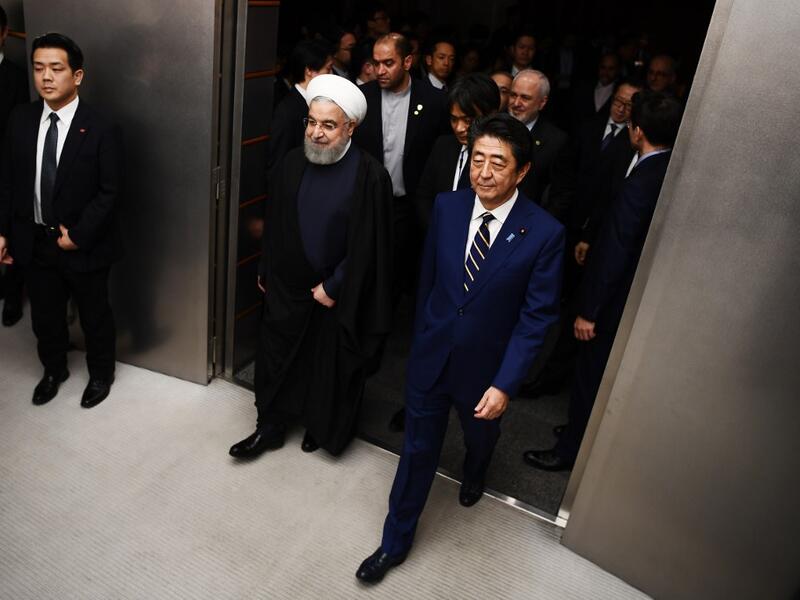 ranian President Hassan Rouhani (L) walks with Japanese Prime Minister Shinzo Abe (R) to a meeting room at the prime minister's office in Tokyo on December 20, 2019. Charly TRIBALLEAU / POOL / AFP