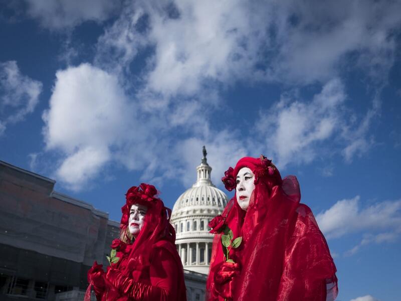 Climate change activists Kathy Beynette, left, and Natalie Pien, right, demonstrate outside of the U.S. Capitol on December 18, 2019 in Washington, DC. Today the U.S. House of Representatives will vote on two articles of Impeachment against U.S. President Donald Trump charging him with abuse of power and obstruction of Congress. Sarah Silbiger/Getty Images/AFP