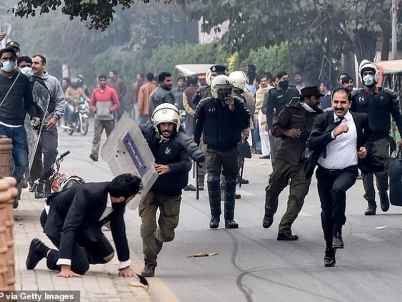 Policemen chase lawyers following a clash between lawyers and doctors in Lahore today (AFP/ File Photo)
