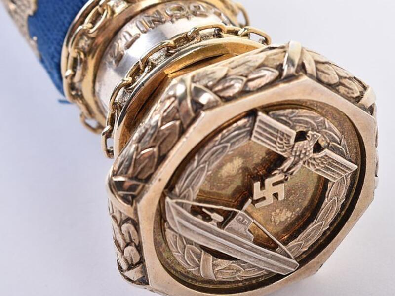 Since his original baton was taken, Donitz's naval comrades had a replica made for him. Pictured: a U-Boat war badge on the end of the item  (Dailymail)