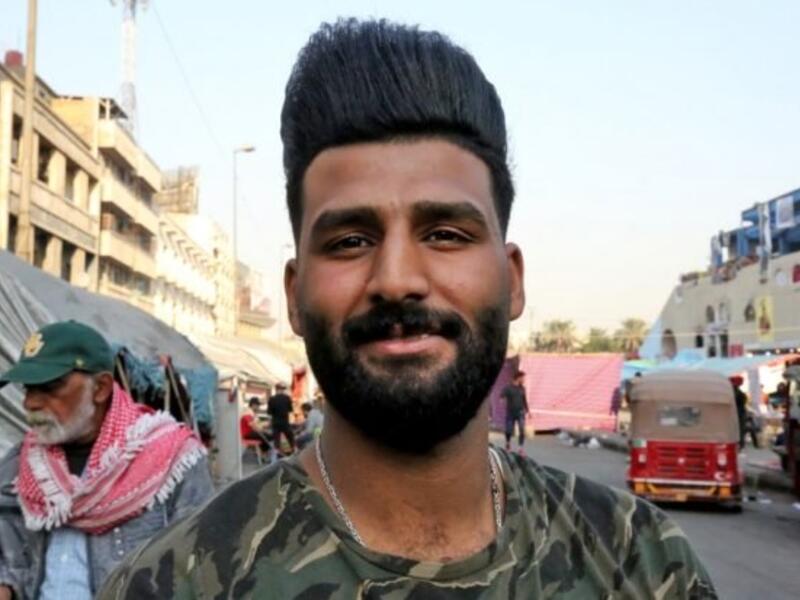 An Iraqi anti-government demonstrator sporting a pompadour hairstyle poses at Tahrir Square in central Baghdad on December 23, 2019. Since the start of Iraq's anti-government protests on October 1, one thing strikes the eye perhaps above all else -- the unbridled hairstyles young men sport. High quiffs, tight fades and loads of attitude -- it is quite the male beauty pageant. SABAH ARAR / AFP