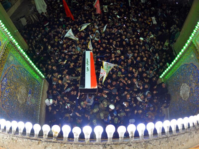 Mourners carry the coffin of slain Iraqi paramilitary chief Abu Mahdi al-Muhandis, toward the Imam Ali Shrine, in the shrine city of Najaf in central Iraq during a funeral procession on January 4, 2020. Thousands of Iraqis chanted "Death to America" today as they mourned the deaths of al-Muhandis and Soleimani, who were killed in a US drone attack that sparked fears of a regional proxy war between Washington and Tehran. Haidar HAMDANI / AFP