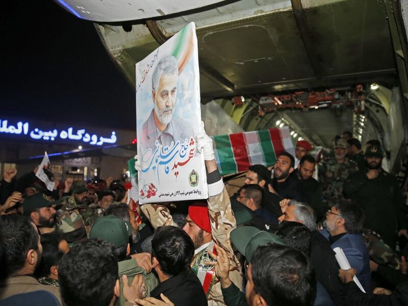 People carry the casket of Iranian commander Qasem Soleimani upon arrival at Ahvaz International Airport in Tehran on January 5, 2020. A tide of mourners packed the streets of the Iranian city of Ahvaz Sunday to pay respects to top general Qasem Soleimani, days after he was killed in a US strike. HOSSEIN MERSADI / fars news / AFP