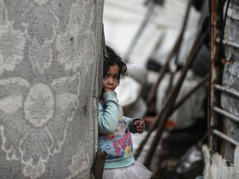 A Palestinian girl pauses as she plays during a cold weather spell in an empoverished neighbourhood on the outskirts in Gaza City on January 9, 2020. MAHMUD HAMS / AFP