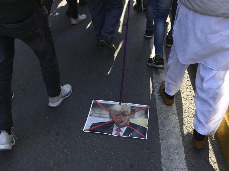 A Muslim protester drags a placard of US president Donald Trump during a protest against the US military action for the killing of the top Iranian general Qasem Soleimani in Iraq, during a demonstration in New Delhi on January 12, 2020. Sajjad HUSSAIN / AFP