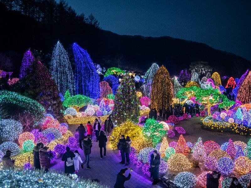 In a photo taken on January 11, 2020 visitors look at an annual light display at the 'Garden on Morning Calm', near Gapyeong, east of Seoul. Ed JONES / AFP
