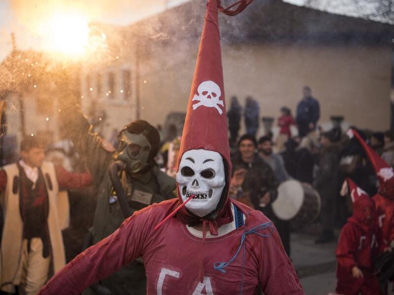Masked revellers take part in a carnival procession through the south-western North Macedonian village of Vevcani, on January 13, 2020. The Vevcani carnival is 1.400 years old and is held every year on the eve of the feast of Saint Basil (January 14), which also marks the beginning of the New Year according to the Julian calendar, observed by the Macedonian Orthodox Church. Robert ATANASOVSKI / AFP