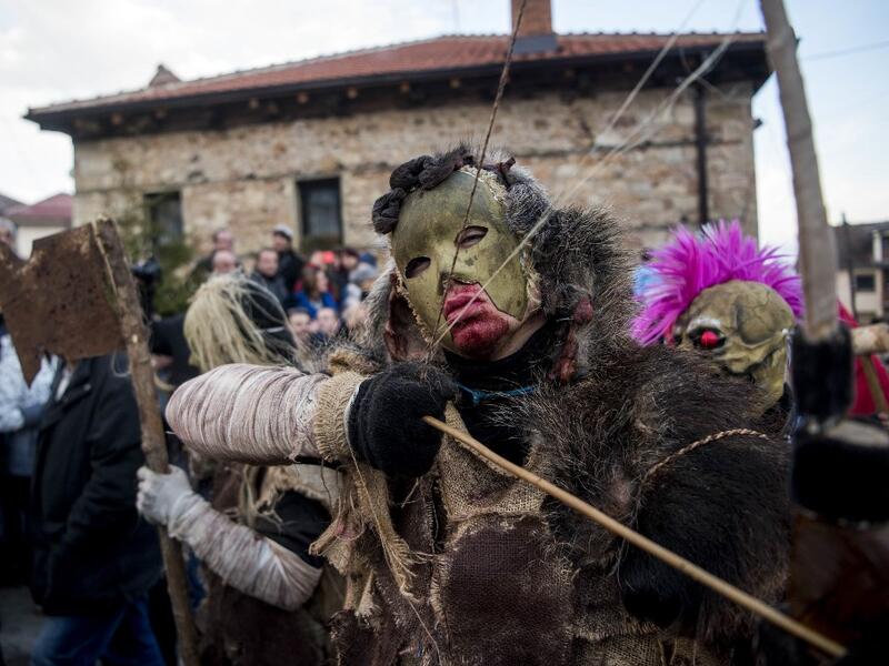 Masked revellers take part in a carnival procession through the south-western North Macedonian village of Vevcani, on January 13, 2020. The Vevcani carnival is 1.400 years old and is held every year on the eve of the feast of Saint Basil (January 14), which also marks the beginning of the New Year according to the Julian calendar, observed by the Macedonian Orthodox Church. Robert ATANASOVSKI / AFP