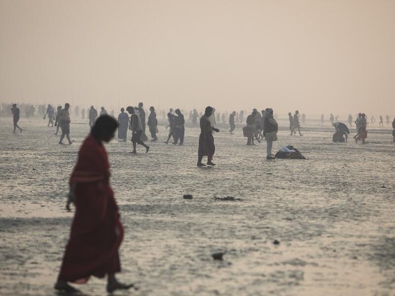 Hindu devotees gather to take a holy dip in the Bay of Bengal during the Gangasagar Mela, at Sagar Island, some 150 kilometres south of Kolkata on January 14, 2020. XAVIER GALIANA / AFP