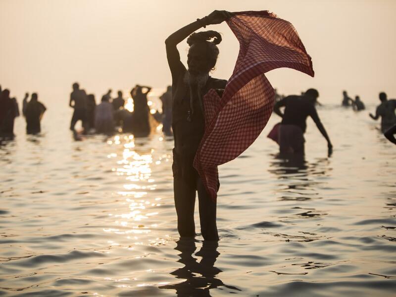 A Hindu Sadhu (holy man) takes a holy dip in the Bay of Bengal during the Gangasagar Mela, at Sagar Island, some 150 kilometres south of Kolkata on January 14, 2020. XAVIER GALIANA / AFP