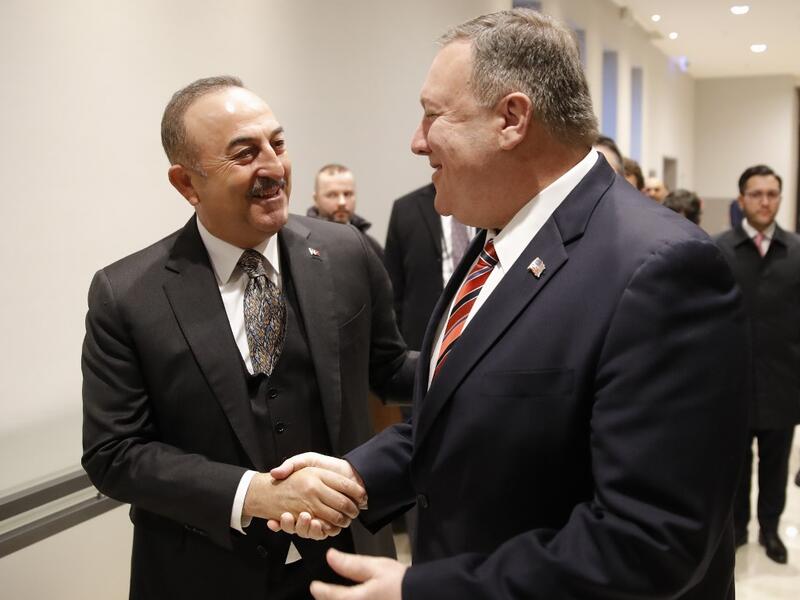 Turkish Foreign Minister Mevlut Cavusoglu (L) shakes hands with US Secretary of State Mike Pompeo as they arrive for a bi-lateral meeting prior a Peace summit on Libya in Berlin on January 19, 2020. AFP