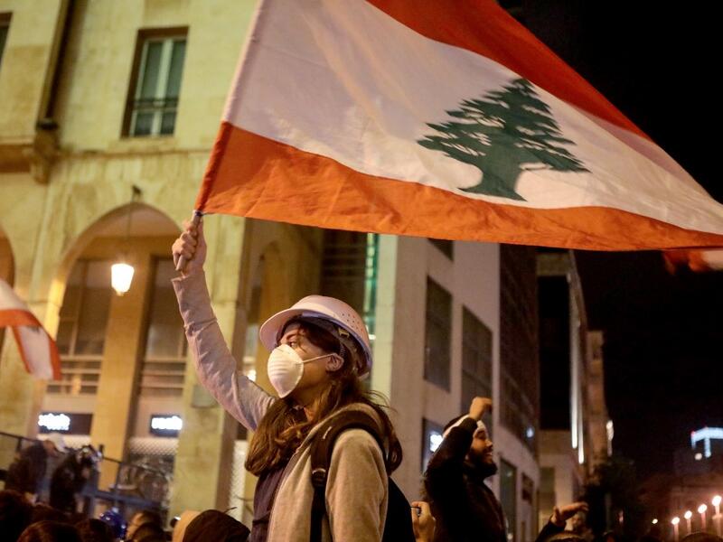 Lebanese protestors wave flags and shout anti-corruption slogans outside the parliament during a protest in downtown Beirut on January 21, 2020. (AFP/ File Photo)