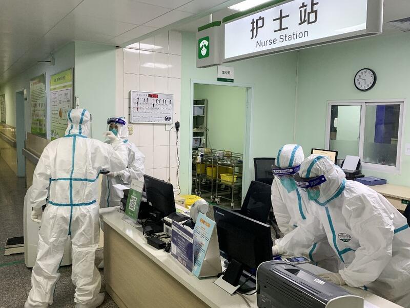 This photo taken on January 22, 2020 shows medical staff members wearing protective suits at the Zhongnan hospital in Wuhan in China's central Hubei province. China banned trains and planes from leaving Wuhan at the centre of a virus outbreak on January 23. (AFP/ File Photo)