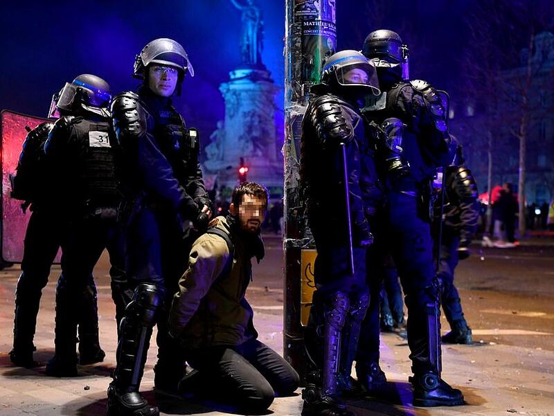 French riot police officers detain a demonstrator on Republic Square (AFP)