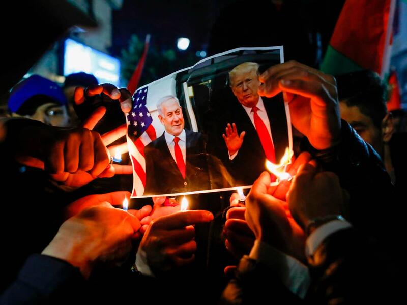 Palestinian protesters burn pictures of US President Donald Trump and Israel's Prime Minister Benjamin Netanyahu during a demonstration in the West Bank against the expected peace plan proposal AFP via Getty