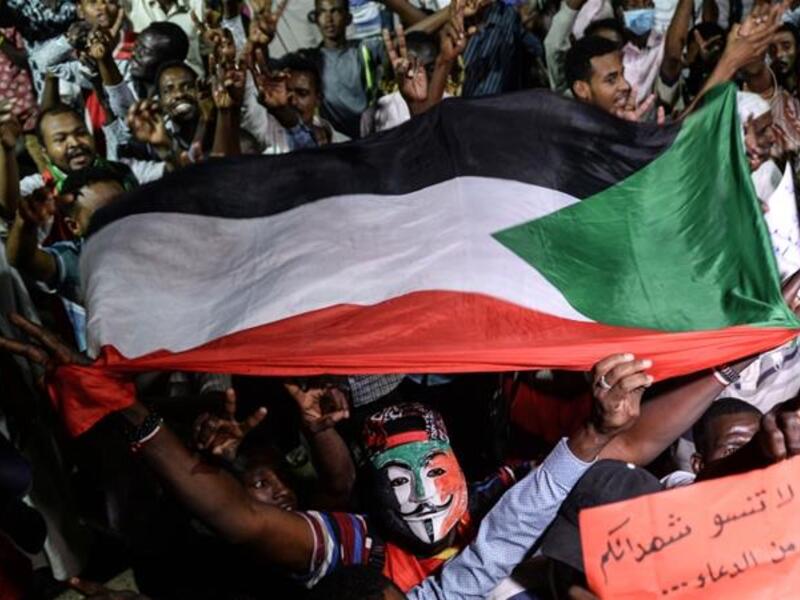Sudanese protesters gather for a sit-in outside the Defence Ministry compound in Khartoum [File: Mohamed el-Shahed/AFP] 
