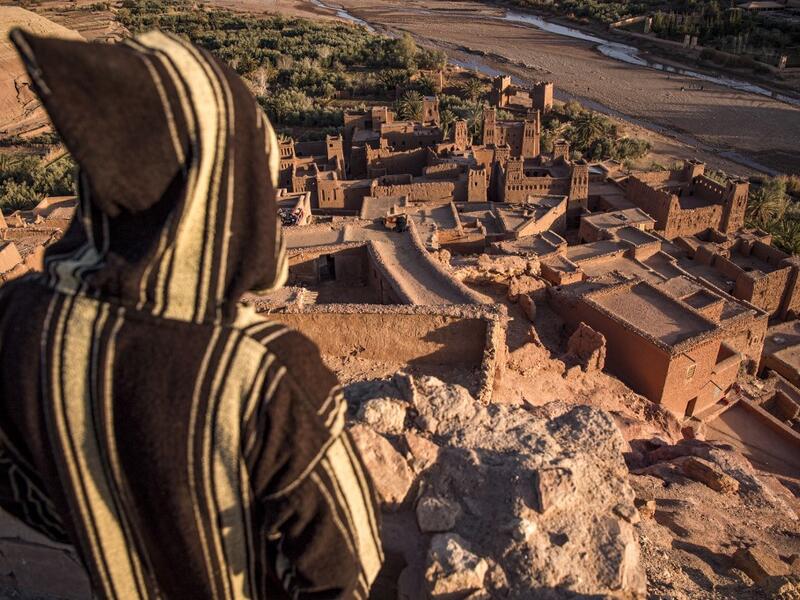 A man stands overlooking the Kasbah (ancient fortress) of Ait-Ben-Haddou, where scenes depicting the fictional city of Yunkai from the hit HBO television series "Game of Thrones" were filmed, about 32 kilometres northwest of the city of Ouarzazate south of Morocco's High Atlas mountains on January 27, 2020.FADEL SENNA / AFP