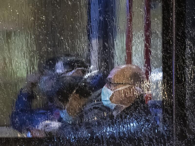 People, wearing masks, are seen through the window of a bus with on board German and foreign nationals evacuated from the Chinese city of Wuhan, the epicentre of the coronavirus outbreak, as the bus leaves Frankfurt am Main's airport to make its way to a military base in Germersheim on February 1, 2020. The passengers were to be examined for symptoms of the virus, which has killed 259 people in China so far, at a specially equipped facility at the airport before being held in quarantine for two weeks at a m