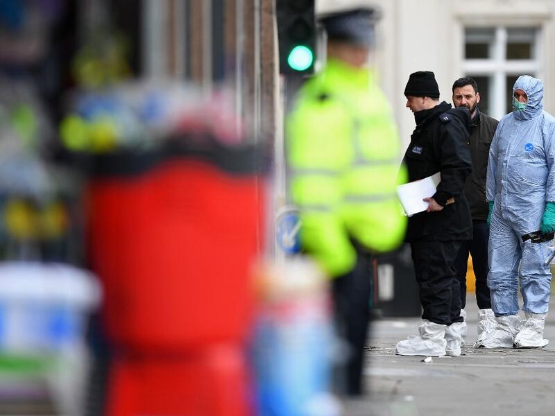 Police forensic officers work outside of a Boots store on Streatham High Road in south London on February 3, 2020, after a man was shot dead by police on February 2, following reports he had stabbed two people. AFP