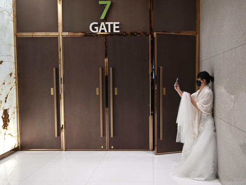 A bride wearing a protective face mask attends a mass wedding ceremony organised by the Unification Church at Cheongshim Peace World Center in Gapyeong on February 7, 2020. South Korea has confirmed 24 cases of the SARS-like virus so far and placed nearly 260 people in quarantine for detailed checks amid growing public alarm. Jung Yeon-je / AFP