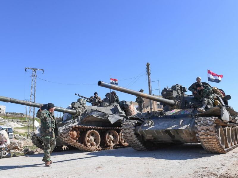 Syrian army units advance in the town of al-Eis in south Aleppo province on February 9, 2020, following battles with rebels and jihadists. Al-Eis, which overlooks the M5, was on a front that saw fierce fighting between the regime and its opponents in 2016. Syrian troops advancing north of Idlib linked up near Al-Eis with their comrades pushing south of Aleppo, state news agency SANA said. The two units had recently waged separate battles in rural Aleppo and southern Idlib, but are now conjoined for the firs
