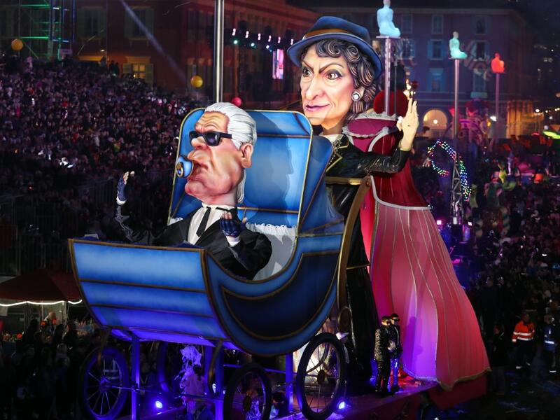 Giant figures depicting German fashion designer Karl Lagerfeld and French fashion designer Coco Chanel are seen during the 136th Nice Carnival parade in Nice, southeastern France, on February 15, 2020. The Carnival takes place until February 29, 2020 on the theme 'King of Fashion'. VALERY HACHE / AFP
