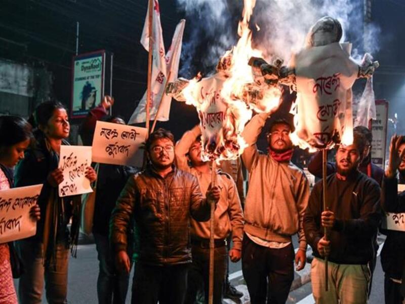 Protesters set fire to effigies of the prime minister and vandalised two BJP offices [Biju Boro/ AFP] 
